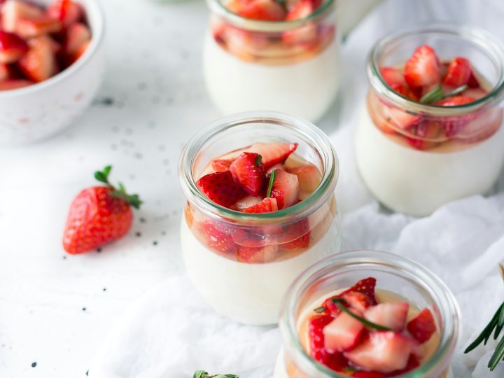 A bowl of homemade yogurt with a wooden spoon