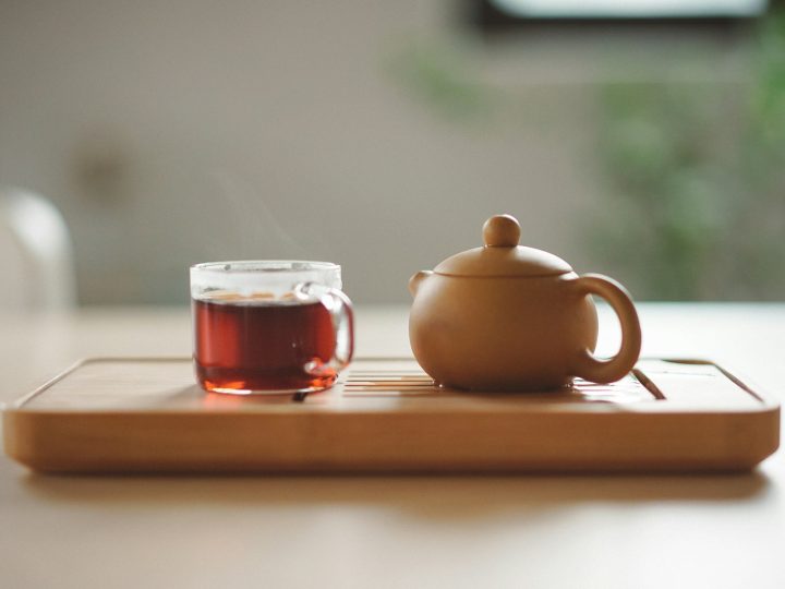 A clay cup of tea with steam in the morning light